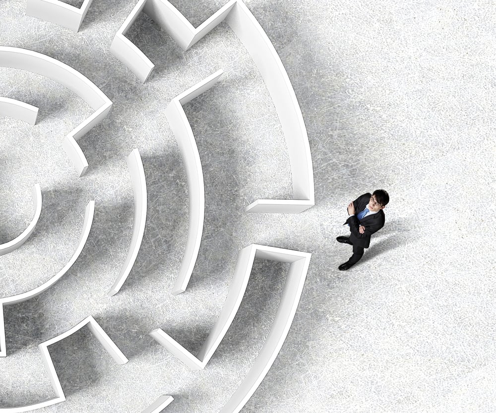 Top view of successful businessman standing near the entrance of labyrinth