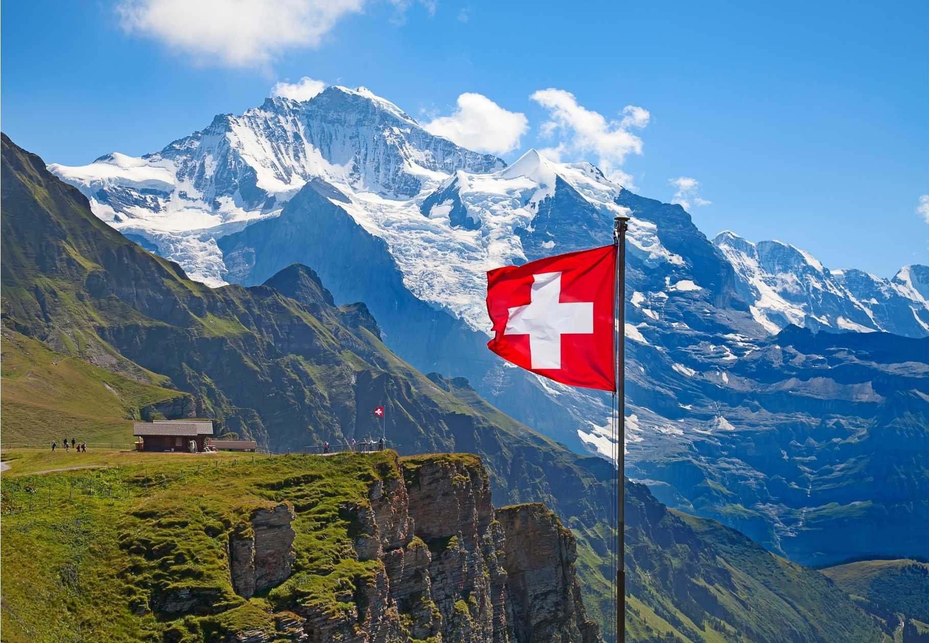 Swiss flag and Swiss Alps