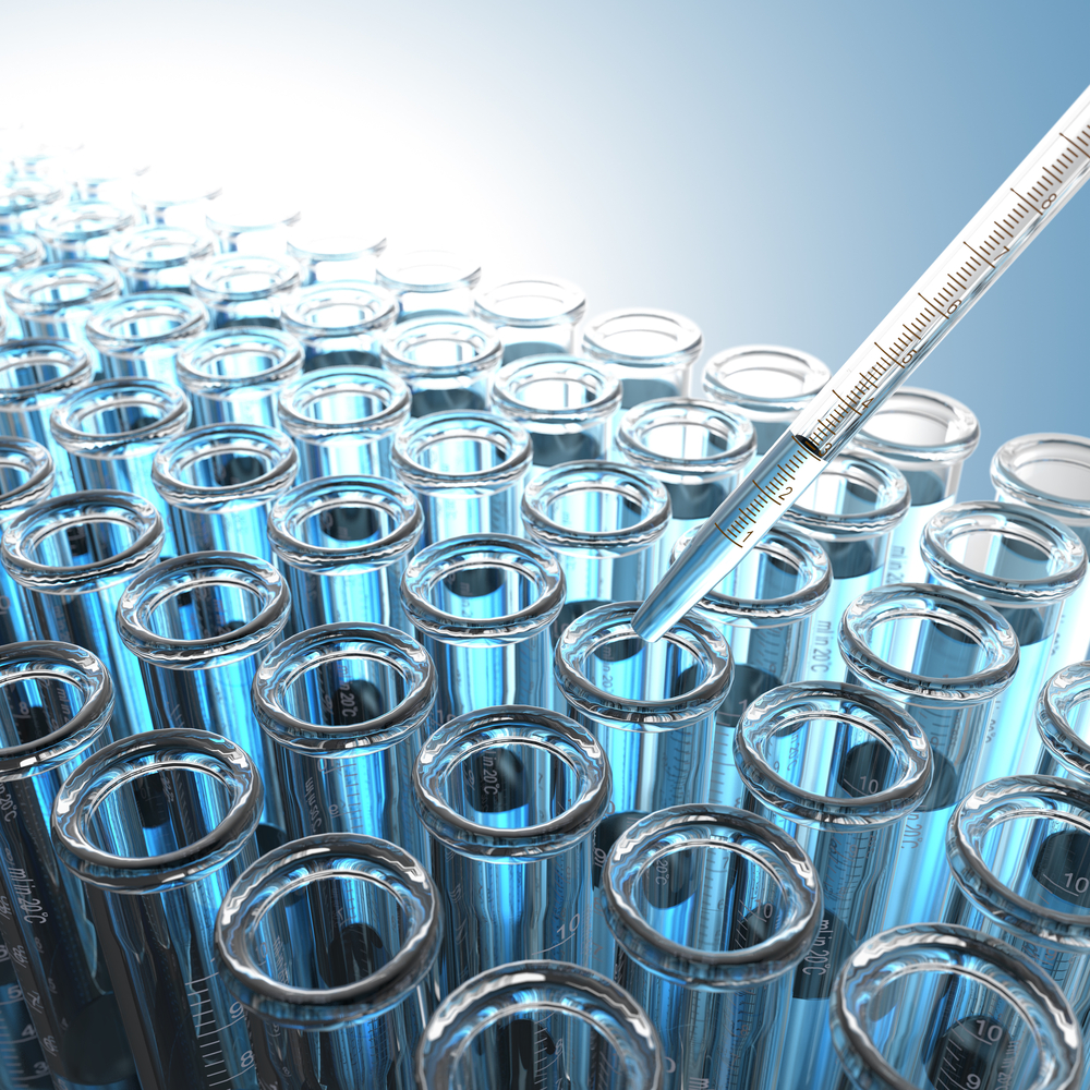 Laboratory Pipette with Blue Liquid Over Glass Test Tubes. Laboratory Pipette with Blue Liquid Over Glass Test Tubes.